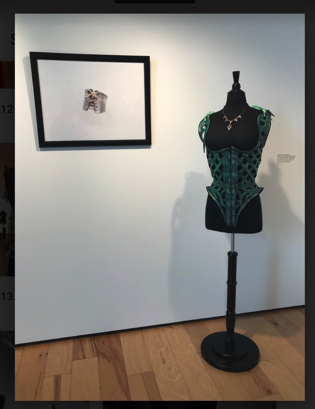 Green lattice corset beside a corset ring sketch, The Corset as Art, SUMA