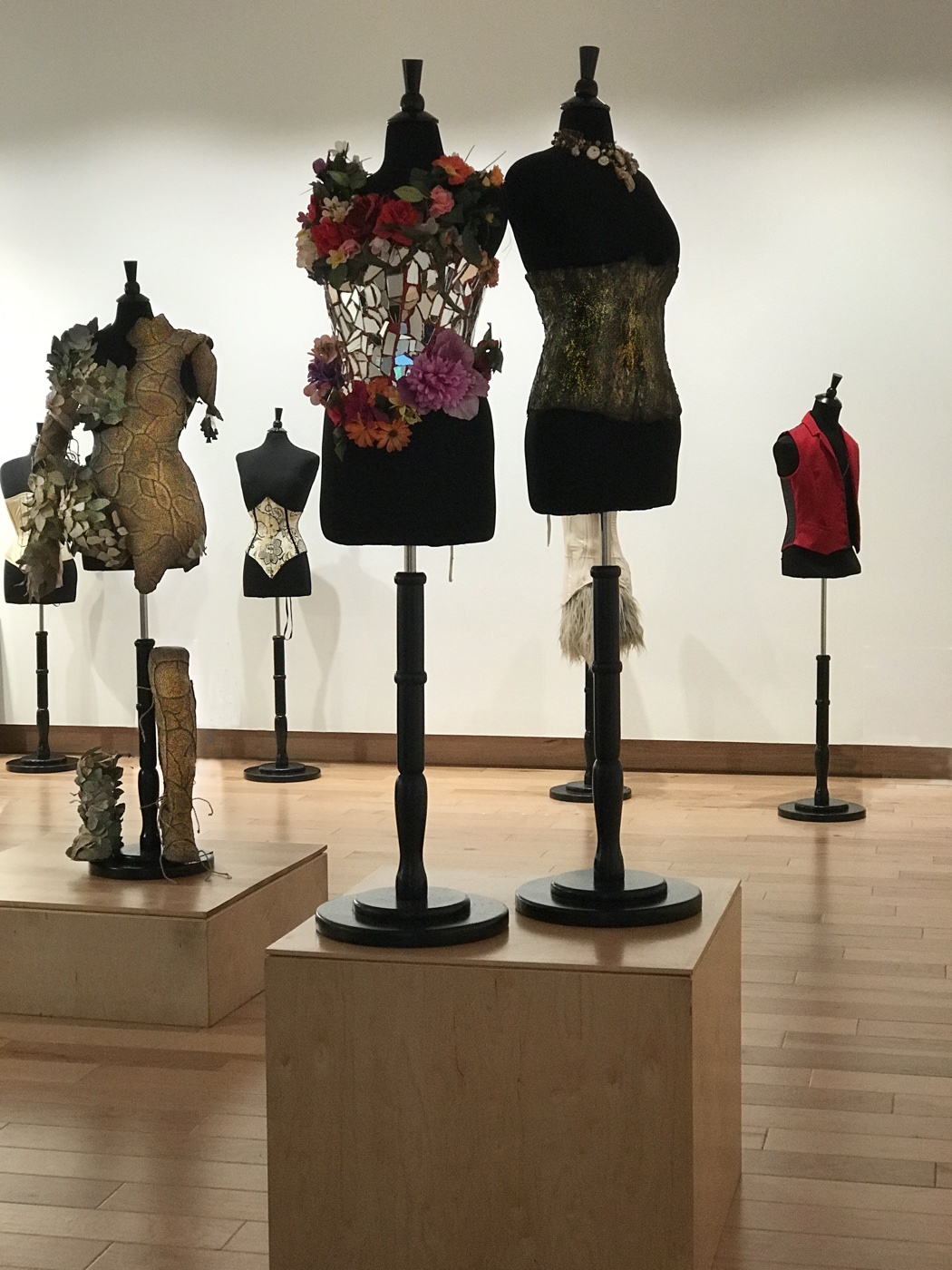 Mixed-media corset installation including a mirrored floral piece and metallic gown, The Corset as Art, SUMA