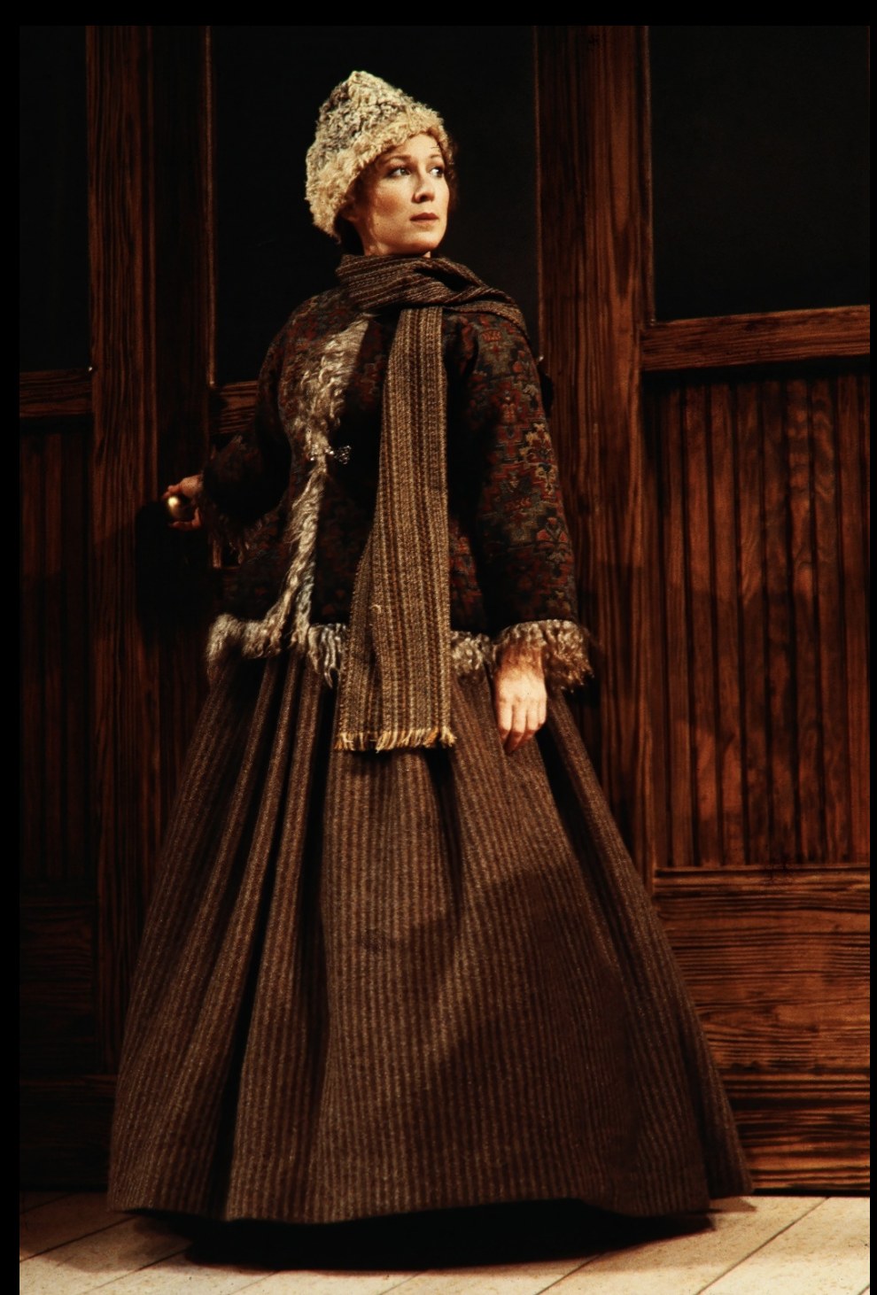 Woman in a dark coat and fur-trimmed hat, An Enemy of the People, Seattle Repertory Theatre, costumes by Laura Crow
