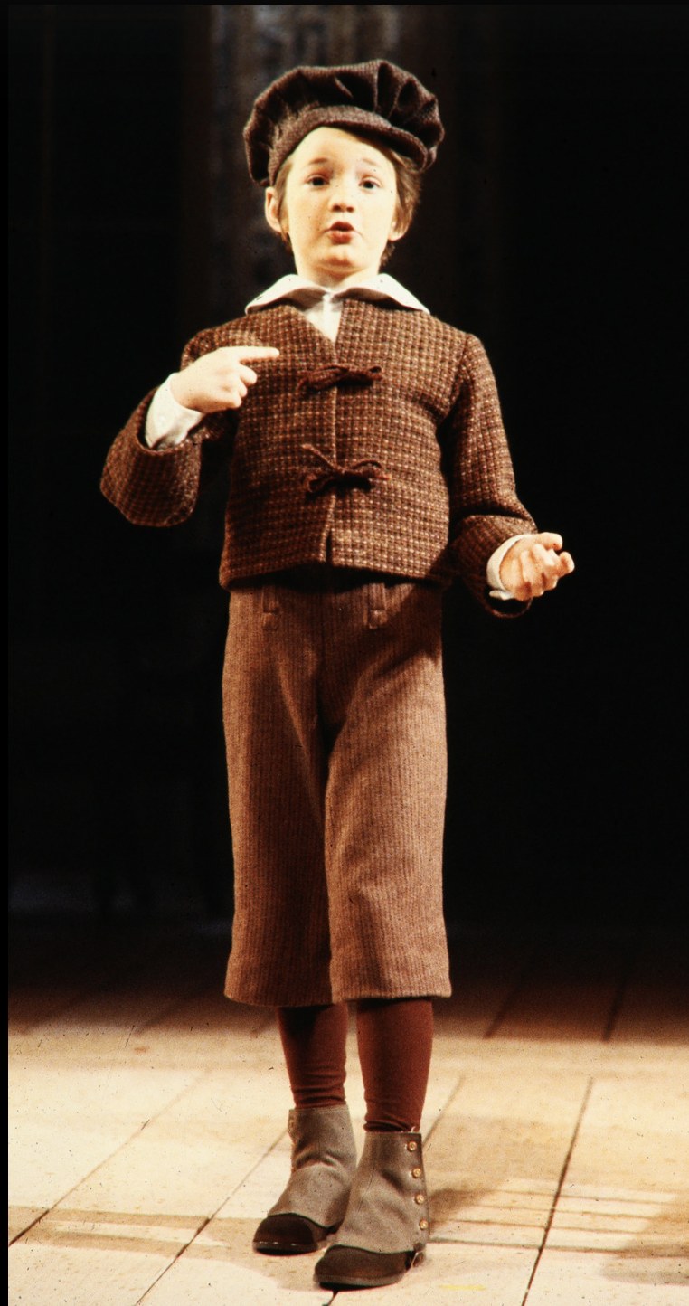 Young performer wearing a brown suit and cap, An Enemy of the People, Seattle Repertory Theatre, costumes by Laura Crow