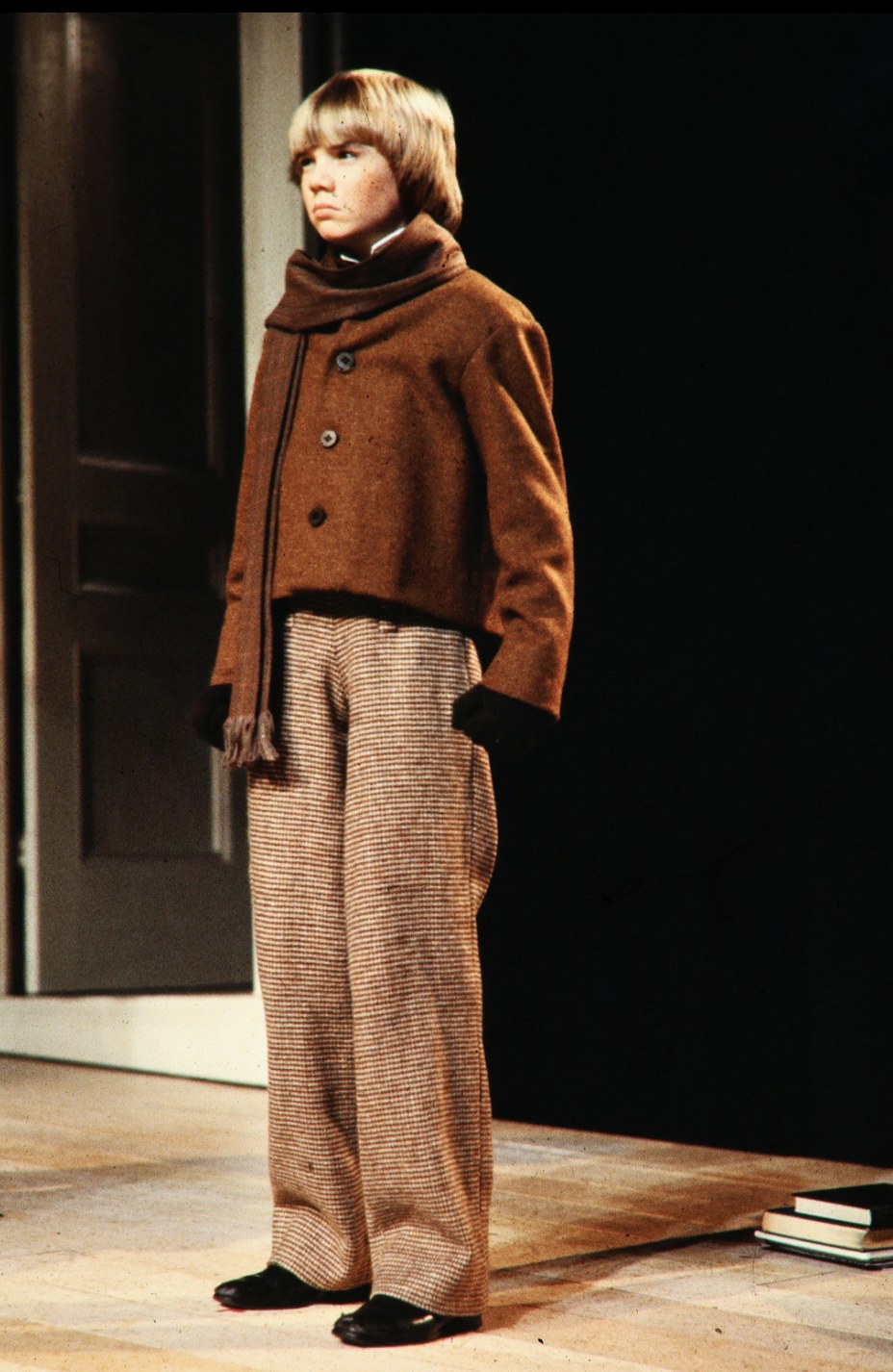 Young performer wearing a scarf and brown jacket, An Enemy of the People, Seattle Repertory Theatre, costumes by Laura Crow