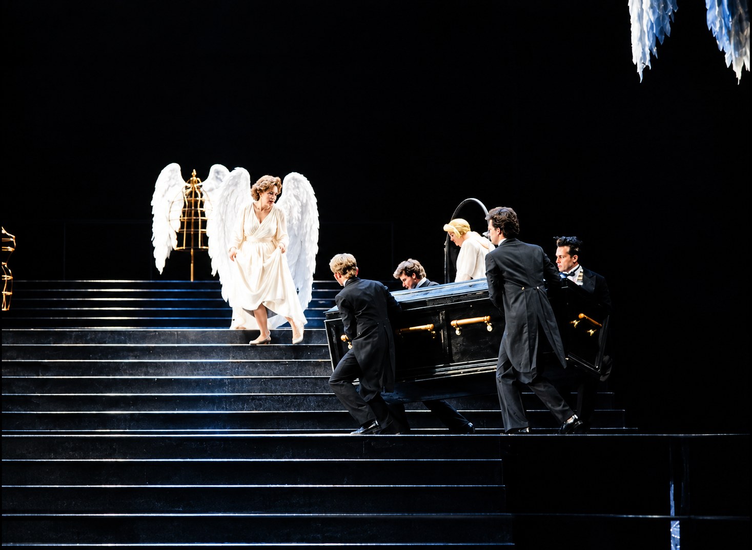 White-clad figures approaching a table on the stairs, Falstaff, University of Michigan, costumes by Laura Crow