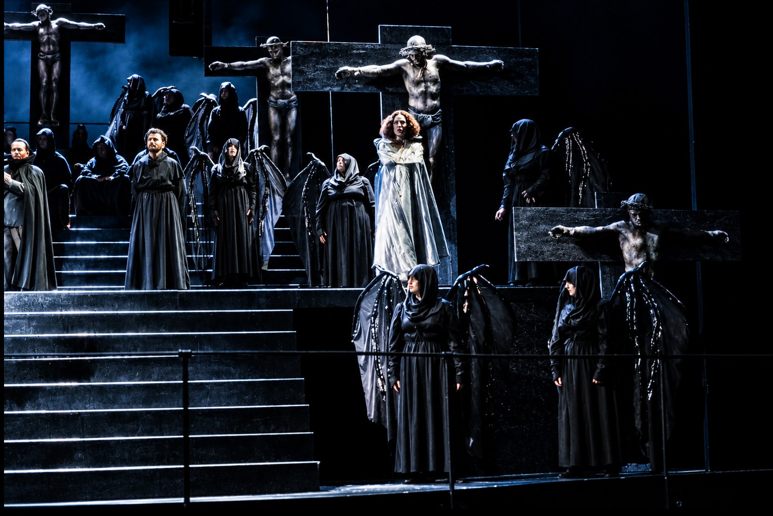 Ensemble arranged on the stairs beneath suspended figures, Falstaff, University of Michigan, costumes by Laura Crow