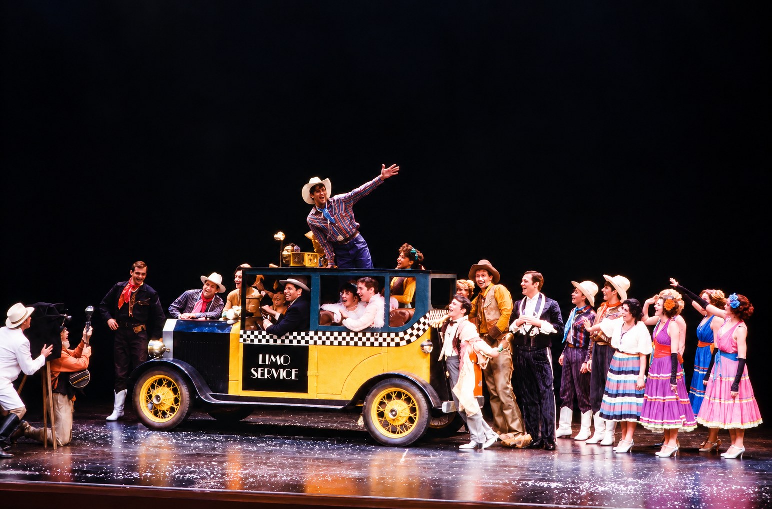 The townspeople surround Eugene, production photo, Girl Crazy, Seattle Repertory Theatre, costumes by Laura Crow