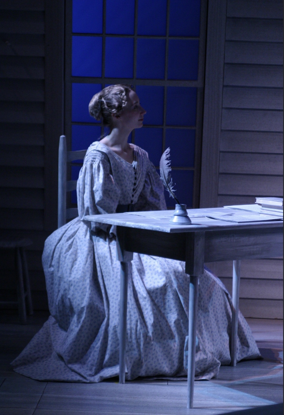 Hillary Parker as Prudence at her writing desk, production photo, Connecticut Repertory Theatre, costumes by Laura Crow