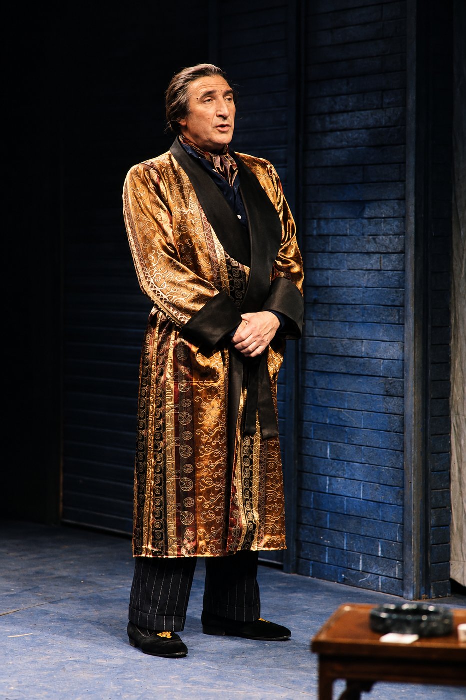 Man in a gold brocade dressing gown, production photo, Robbers, Long Wharf Theatre, costumes by Laura Crow