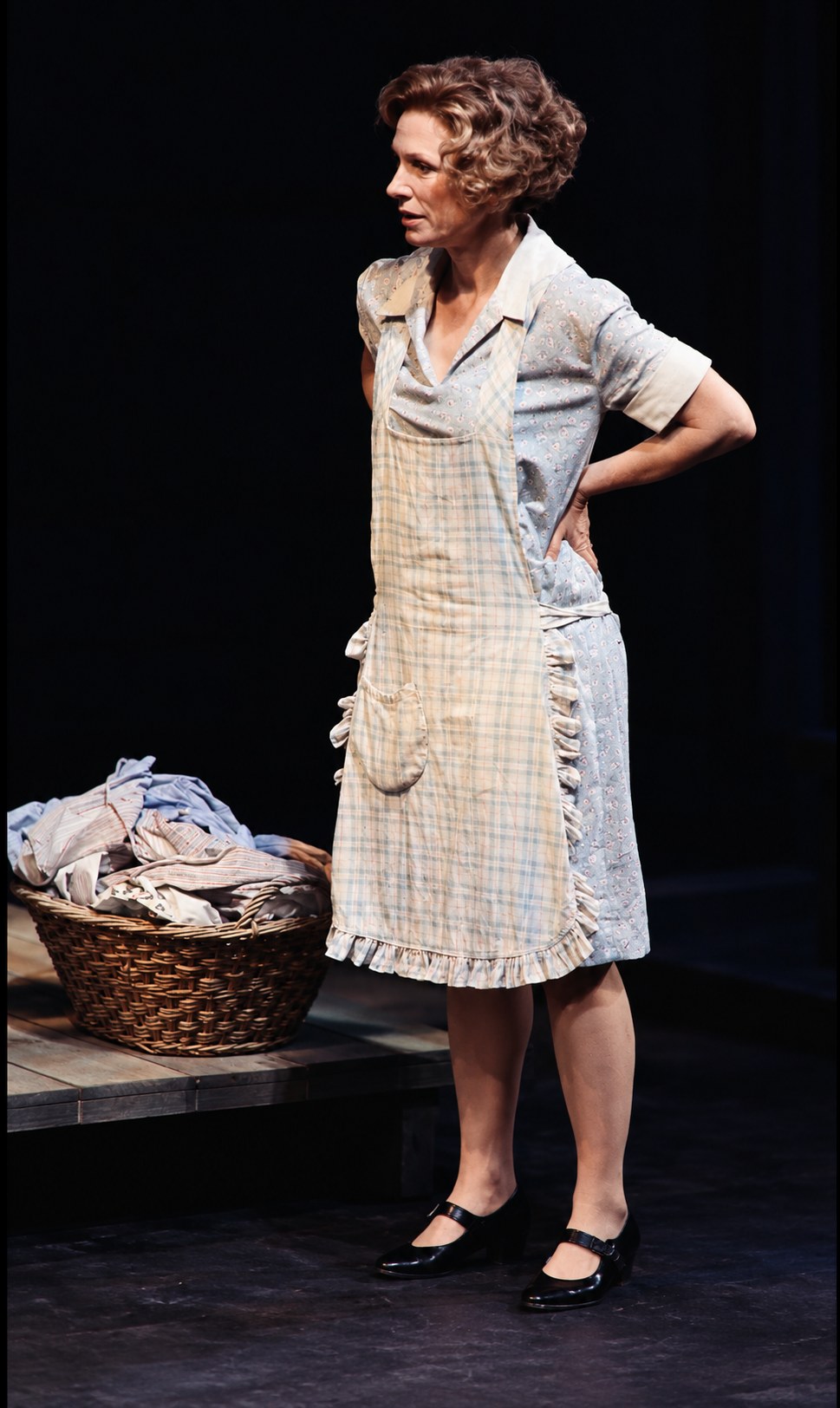 Linda standing beside a laundry basket, Death of a Salesman, Alley Theatre, Houston, costumes by Laura Crow