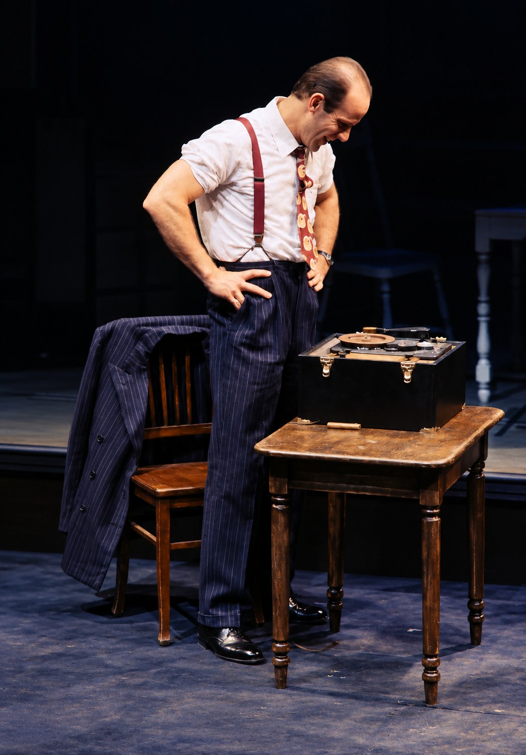 Man leaning over an open case, Death of a Salesman, Alley Theatre, Houston, costumes by Laura Crow