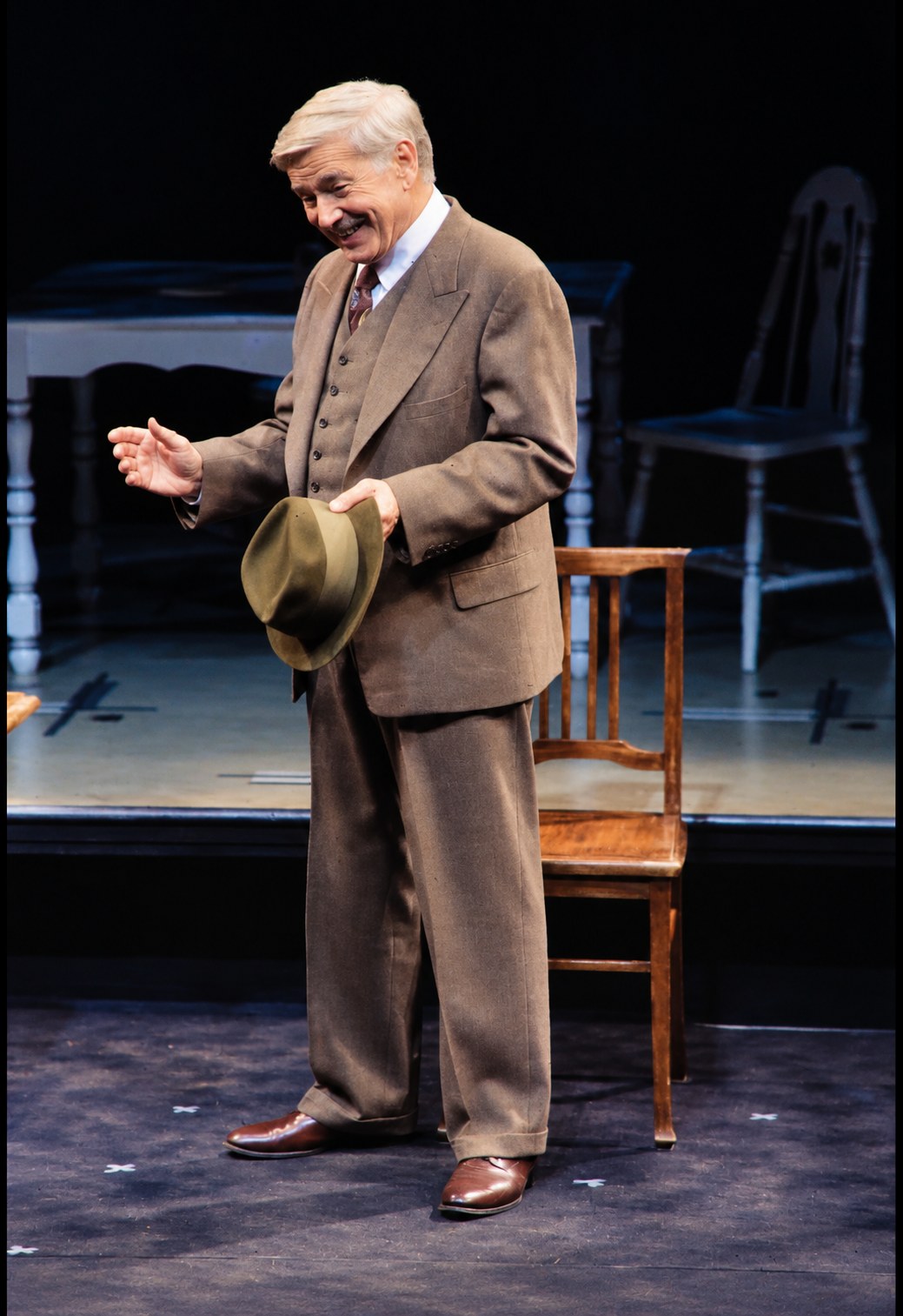 Willy in a brown suit holding his hat, Death of a Salesman, Alley Theatre, Houston, costumes by Laura Crow