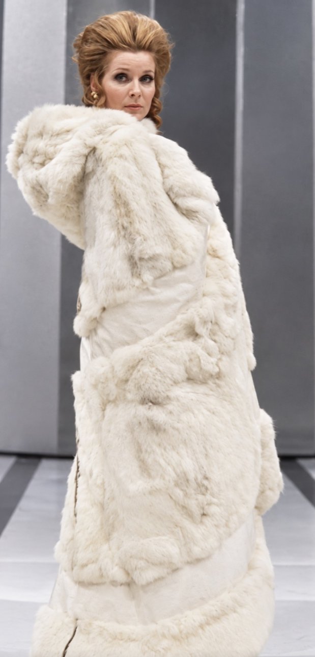 Adrienne Corri in a white fur wrap coat, Servants and the Snow, Greenwich Theatre, costumes by Laura Crow