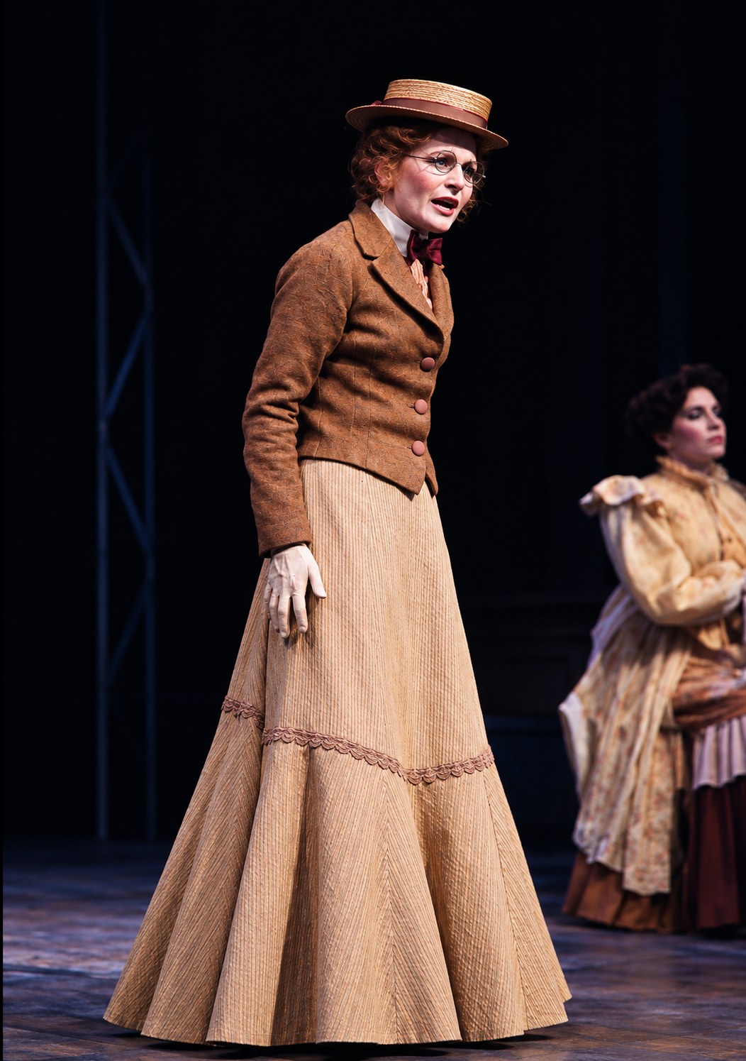 Performer in a brown jacket and skirt, Tintypes, Seattle Repertory Theatre, costumes by Laura Crow