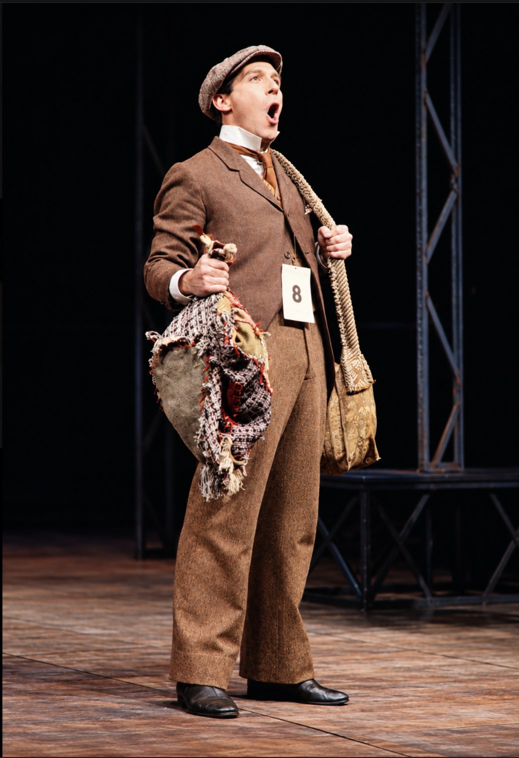 Performer in a brown suit and cap, Tintypes, Seattle Repertory Theatre, costumes by Laura Crow