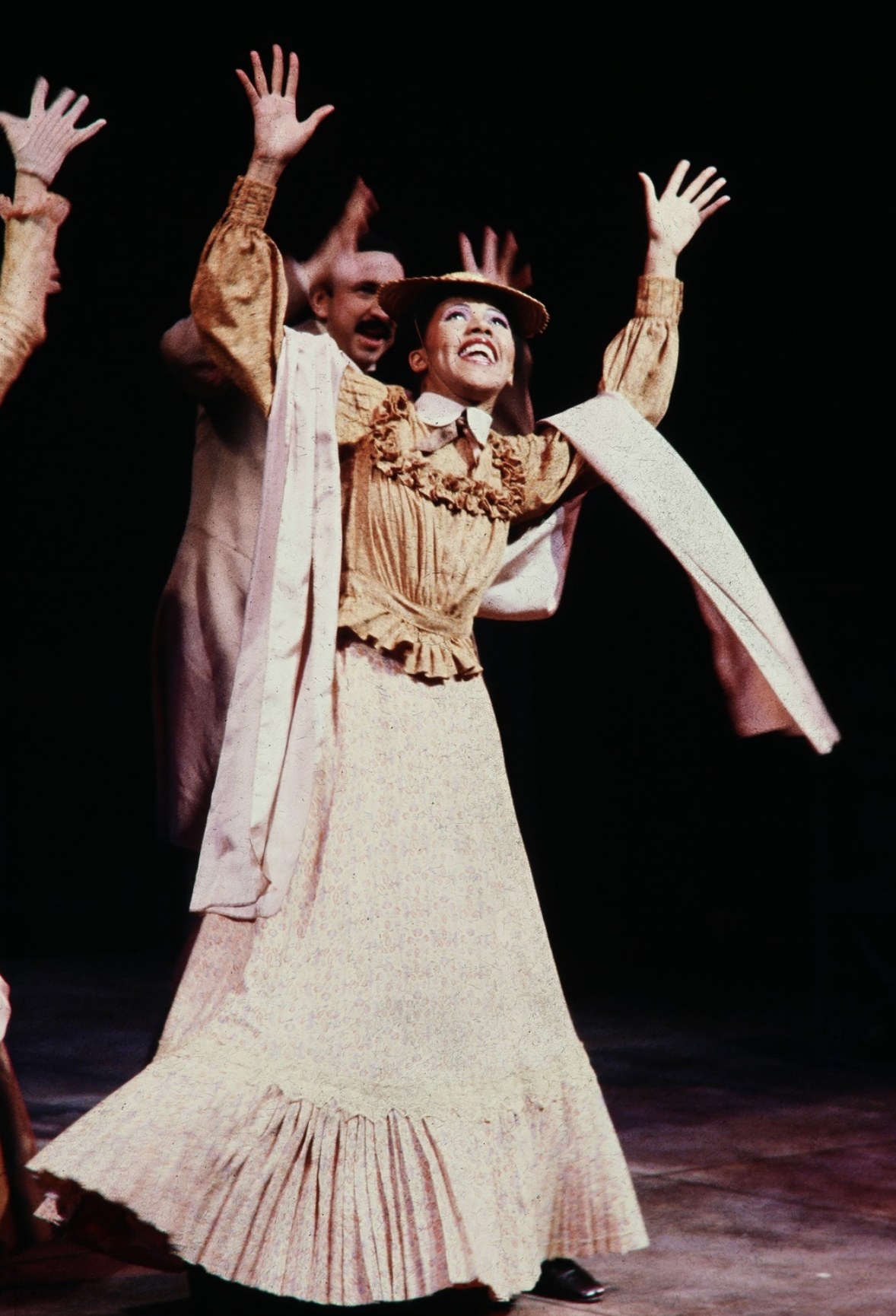Performer raising her arms in a pale dress, Tintypes, Seattle Repertory Theatre, costumes by Laura Crow